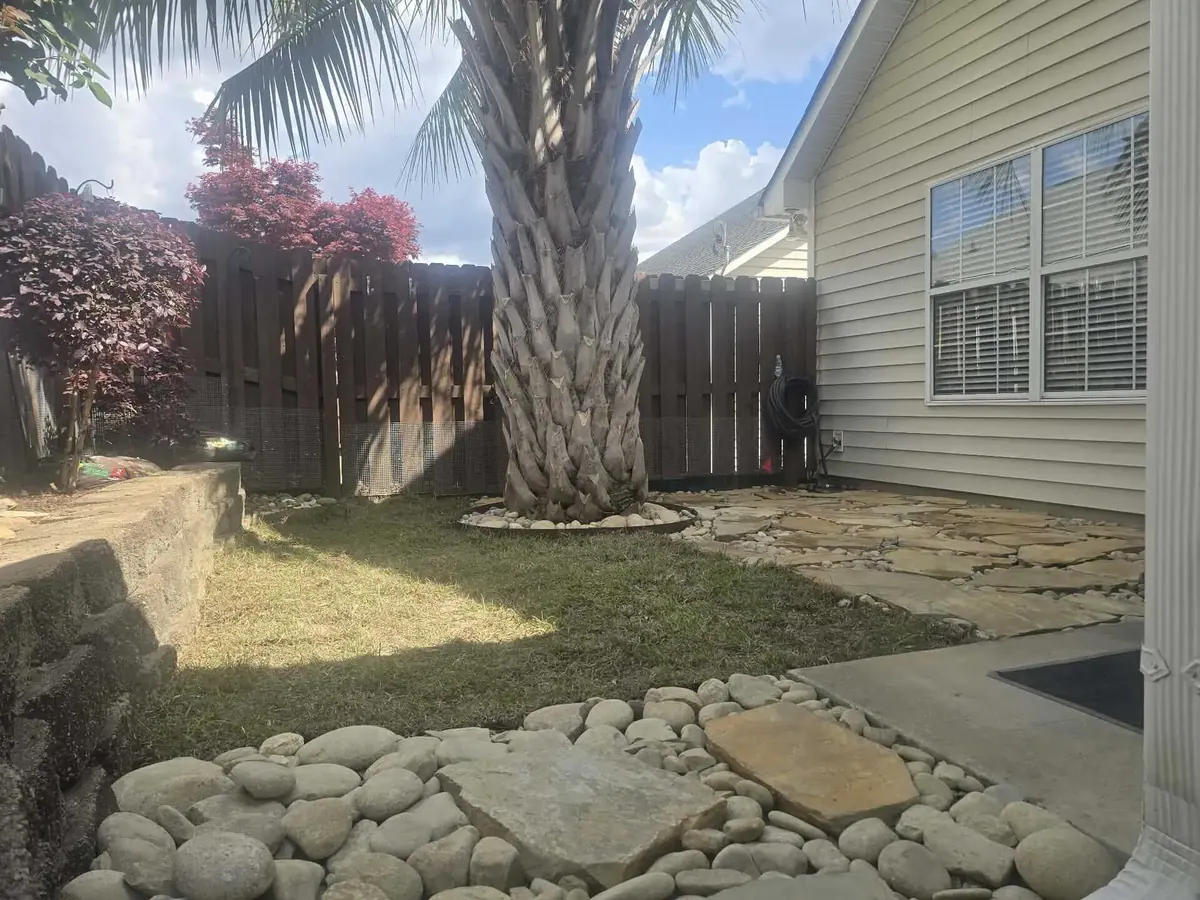 After: river rock drainage path with stepping stones in a side yard