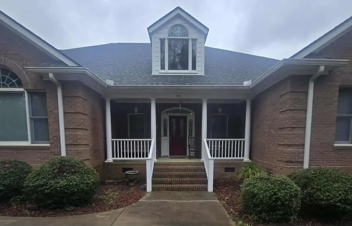 Before: the same brick home before landscape lighting