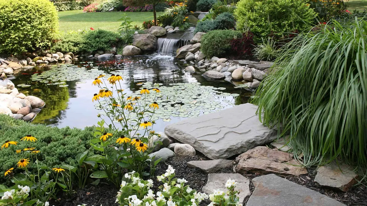 Custom water feature and planting bed installed by H2Os